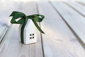White paper house layout wrapped in green ribbon with bow. small