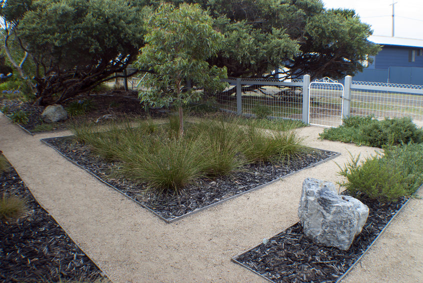 Use native plants and smart irrigation systems for a greener grass. This flowerbed would be great for drip irrigation.