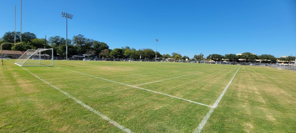 a grass healthy field that needs watering properly used for unified sports soccer tournament